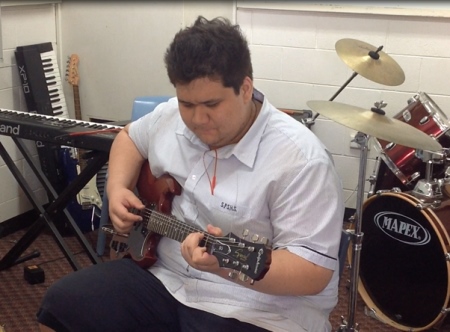 Student playing a guitar